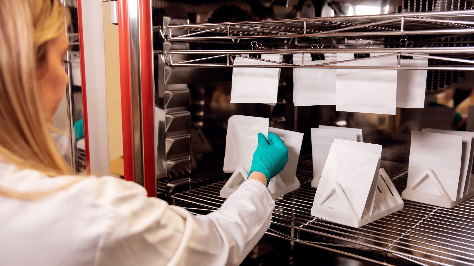 Unilever scientist testing paper-based materials to see if they will retain their quality, strength and appearance throughout the supply chain.