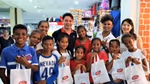 Group of young children holding Lifebuoy bags at an event to launch the brand in East Timor.
