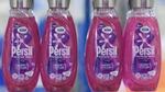 Four bottles of Persil Wonder Wash on a production line.