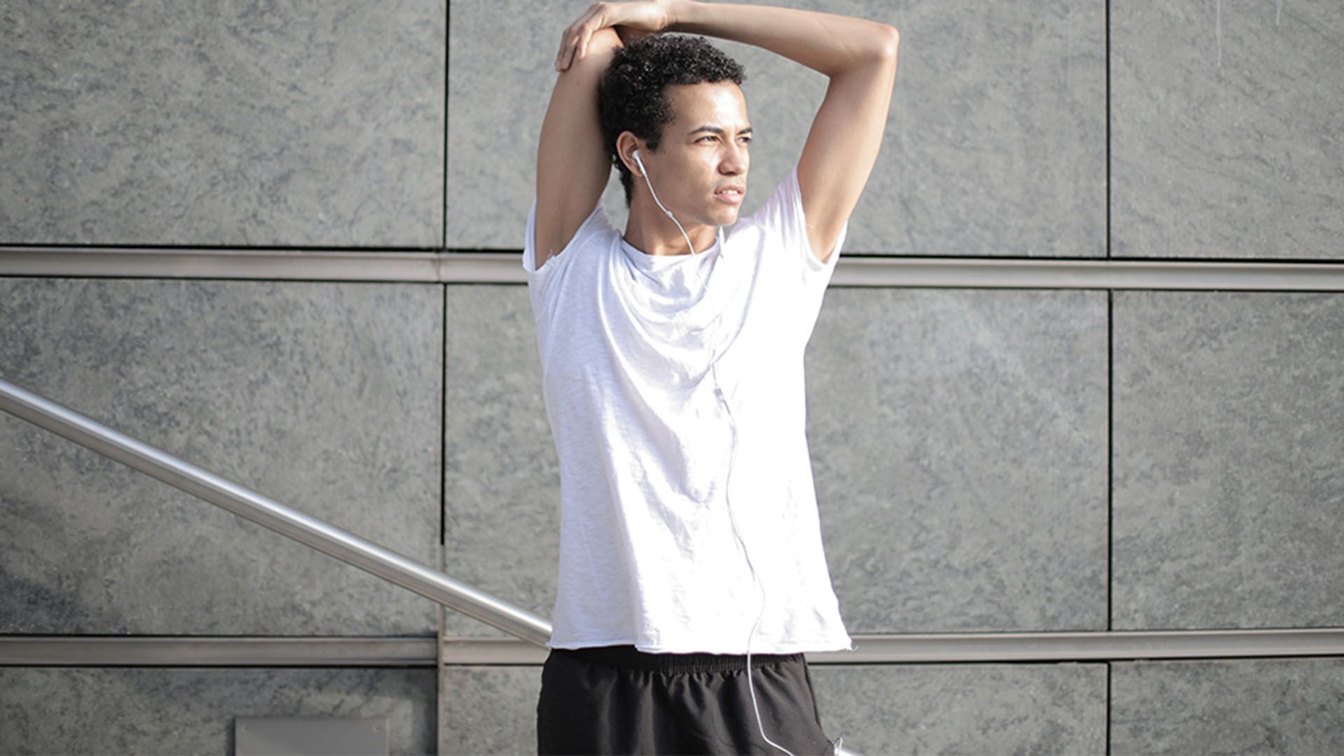 Man with one arm raised so you can see his armpit