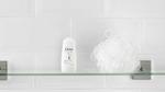 Baby Dove products on a bathroom shelf with a blue soft rabbit toy next to them