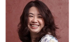 A photo of Unilever microbiome scientist Cheri Chu. Cheri has dark shoulder-length hair and is smiling into the camera.