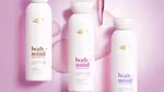 Three Dove Body+Mind serum body wash bottles displayed on a pink background with liquid droplets.