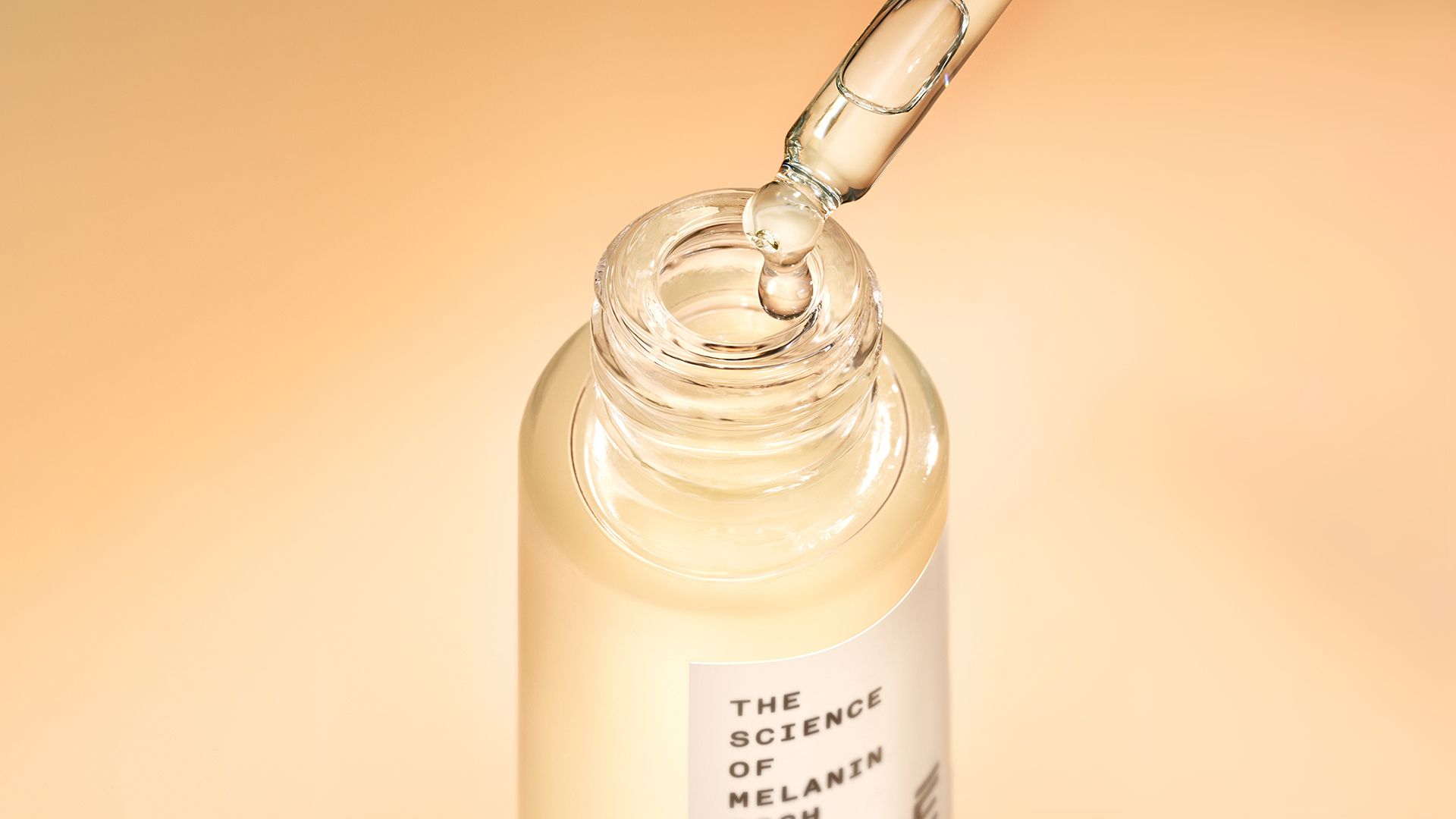 A bottle of Mele’s Most No Shade Sunscreen Oil on a golden background