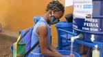 Student girl washing her hands outdoors