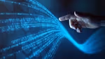 A hand (caucasian skin tone) points to data flowing onto a blue screen