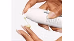 A Dermalogica product being dispensed onto someone’s fingers.