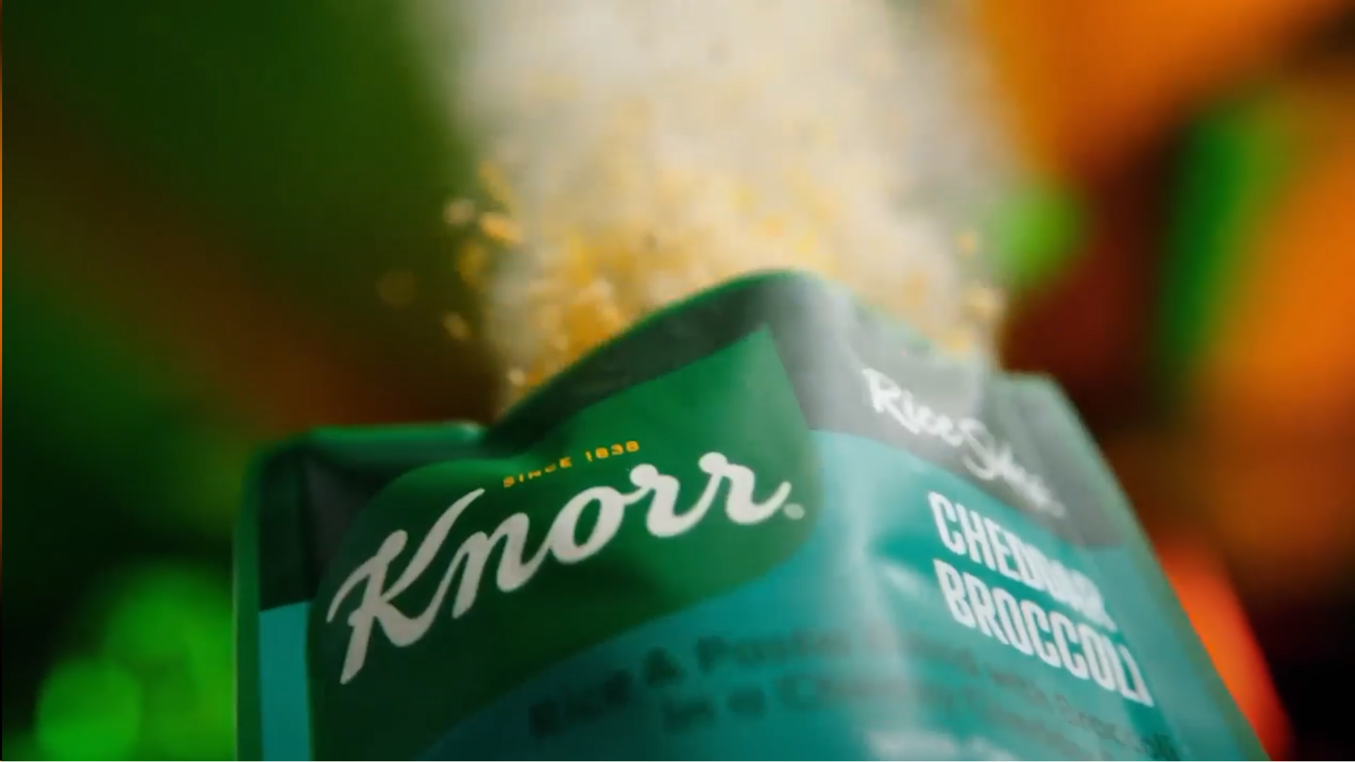 An opened packet of Knorr with powder bursting out.