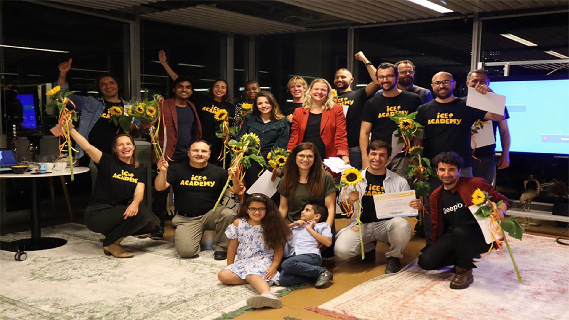 Group of people holding sunflowers