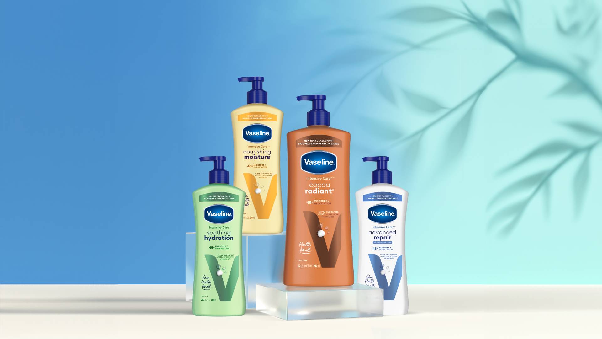 Four Vaseline Intensive Care lotions, including ‘Soothing Hydration’, ‘Nourishing Moisture’, ‘Cocoa Radiant’ and ‘Advanced Repair’. Each bottle is equipped with a pump dispenser. The products are arranged in front of a blue background, with a leaf motif.