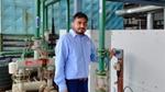 Kothiya Jaydeep from Unilever Hindustan beside a heat pump used to heat water, eliminating the need for diesel