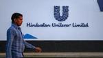 A man walking outside a Hindustan Unilever building