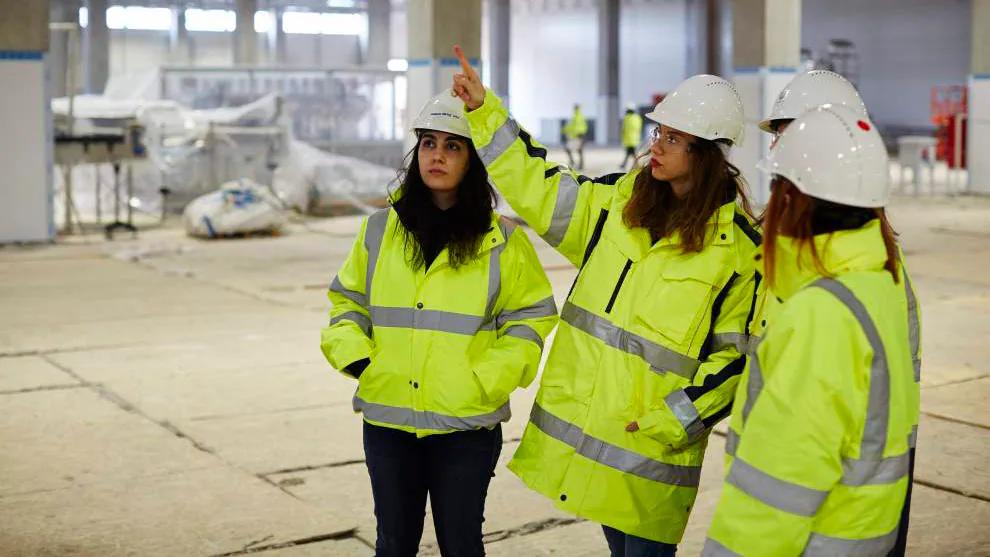 A group of employees in hi-vis jackets and hard hats