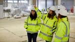 A group of employees in hi-vis jackets and hard hats