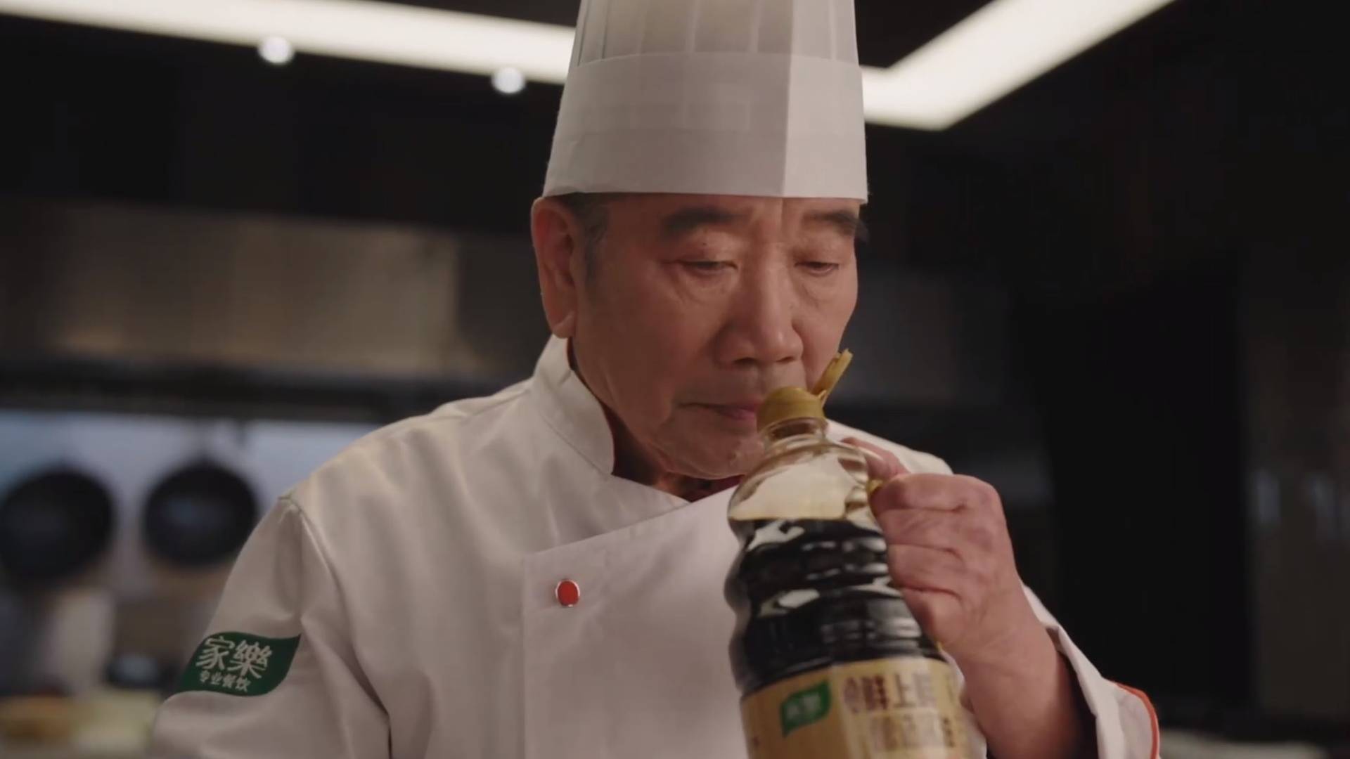 A chef in a white toque smells the new professional soy sauce launched by Unilever Food Solutions.