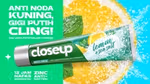 A tube of Closeup Lemon & Sea Salt toothpaste displayed against the background of a lemon slice.