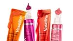 Four brightly coloured tubes of Vaseline Gluta Hya lip serum with product dripping from the tubes set on a white background.