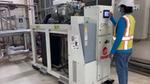 A factory worker programmes a heat pump in our Personal Care factory in Dubai.