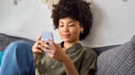 Person sitting on a couch using a smartphone