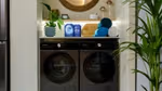 Persil and Comfort Smart Series laundry detergent and conditioner sitting on top of Samsung smart auto-dose washing machine.
