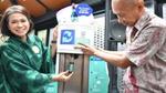 Woman and man using a refill station for Bango soy sauce in the Saruga packaging-free store in Bintaro, Indonesia.