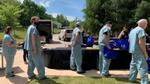 Medics at Mercy Hospital queuing up to receive Unilever gift bags, some holding prepacked meals