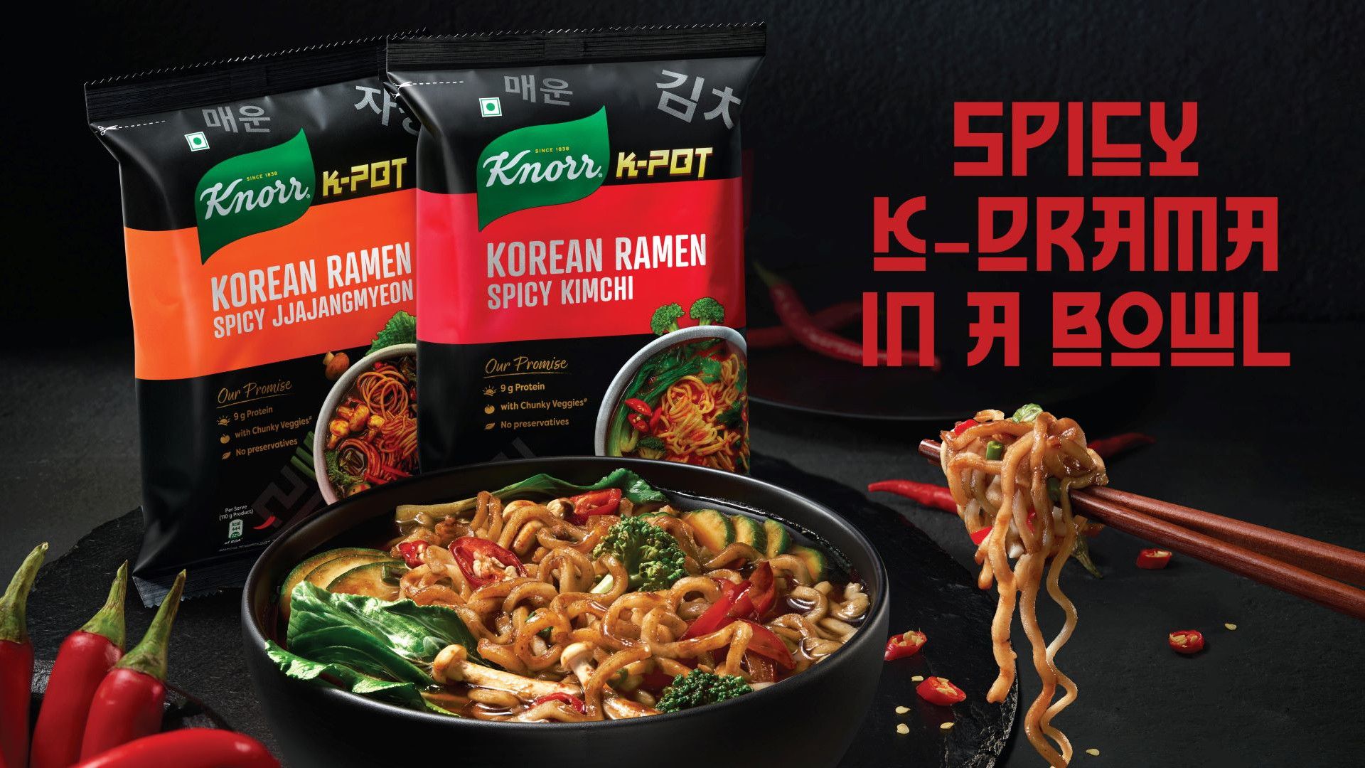An image of red chopsticks lifting noodles from a bowl of Knorr Mini Meal noodles.
