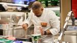 A chef from Unilever Food Solutions sprinkling some Knorr product into a tray