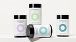 Four jars of Nutrafol products which are designed to help hair health for women and men at various stages in their lives.