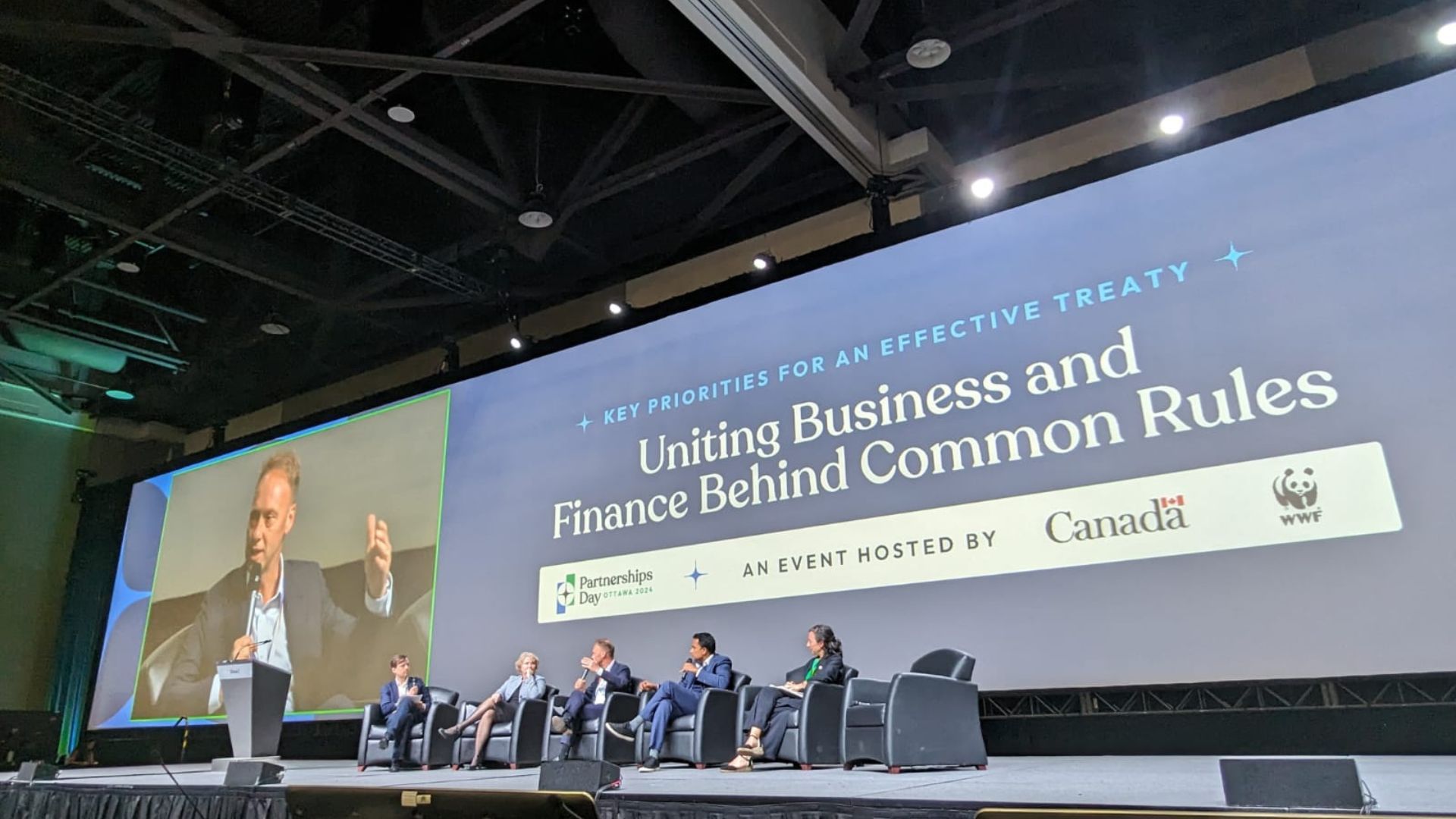 Five panellists seated on a stage under a large screen displaying the title 'Key priorities for an effective treaty: uniting business and finance behind common rules'. Unilever CEO Hein Schumacher is addressing the audience.