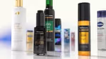 A close-up display of various hair and skincare products arranged on a reflective surface, including Dove Bond Strength conditioner, TRESemmé Silk Press serum, TRESemmé Lamellar Gloss finishing oil, and other branded items in the background.