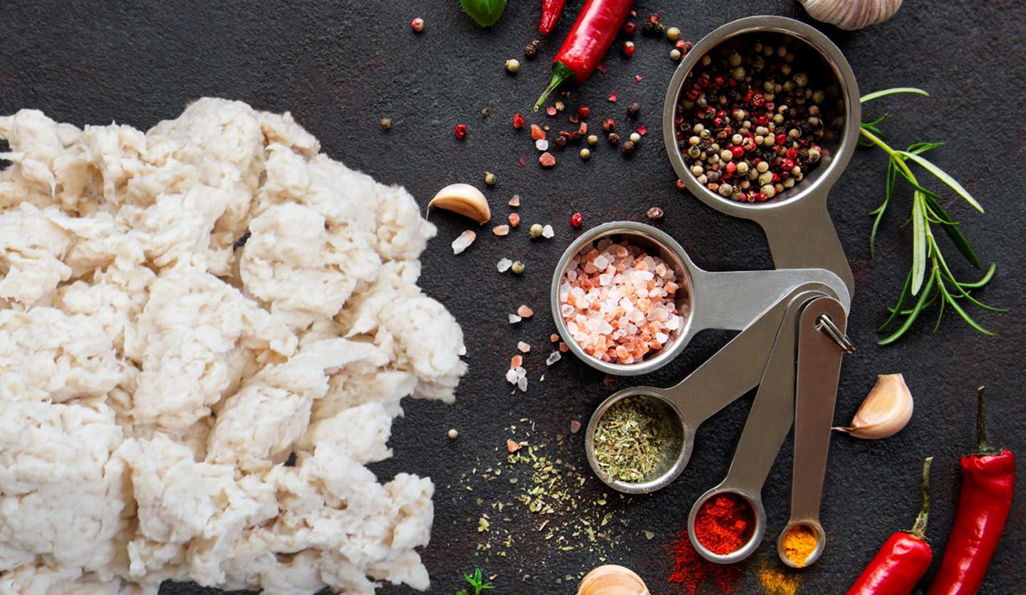 Fungi-based plant protein ABUNDA, developed by food tech firm ENOUGH, sitting on working surface with spices