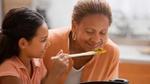 A grandmother and grandchild cooking