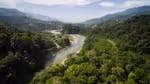 A river winds through trees and hills.