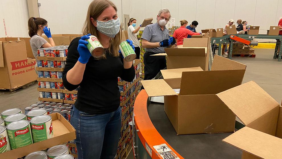 Woman packing items for United for America, an initiative designed to support communities in need during Covid-19.
