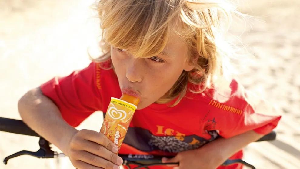 A young boy eating a Calippo