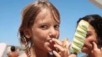 A young girl eating a Twister ice lolly