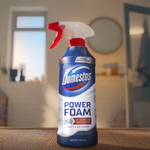 A blue bottle of Domestos power foam on a kitchen counter.