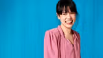 Woman in pink blouse laughing