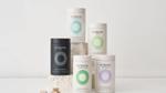 Collection of Nutrafol hair growth supplement containers arranged on stone blocks, featuring variants for men and women.