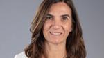 Unilever’s Nuria Hernadez-Crespo. Nuria is white with shoulder-length brown hair. She is wearing a white shirt and smiling.