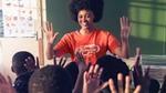 A teacher wearing a Lifebuoy t-shirt in class