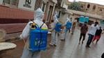 Men at work, with containers of Domex disinfectant strapped to their backs