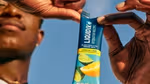 A man opening a packet of Liquid I.V. Electrolyte Drink Mix Lemon Lime.