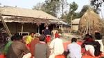 A group of people sitting in a village