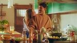 In a still from Knorr’s Green Flag social influencer marketing campaign, a woman hugs a man while he is cooking.