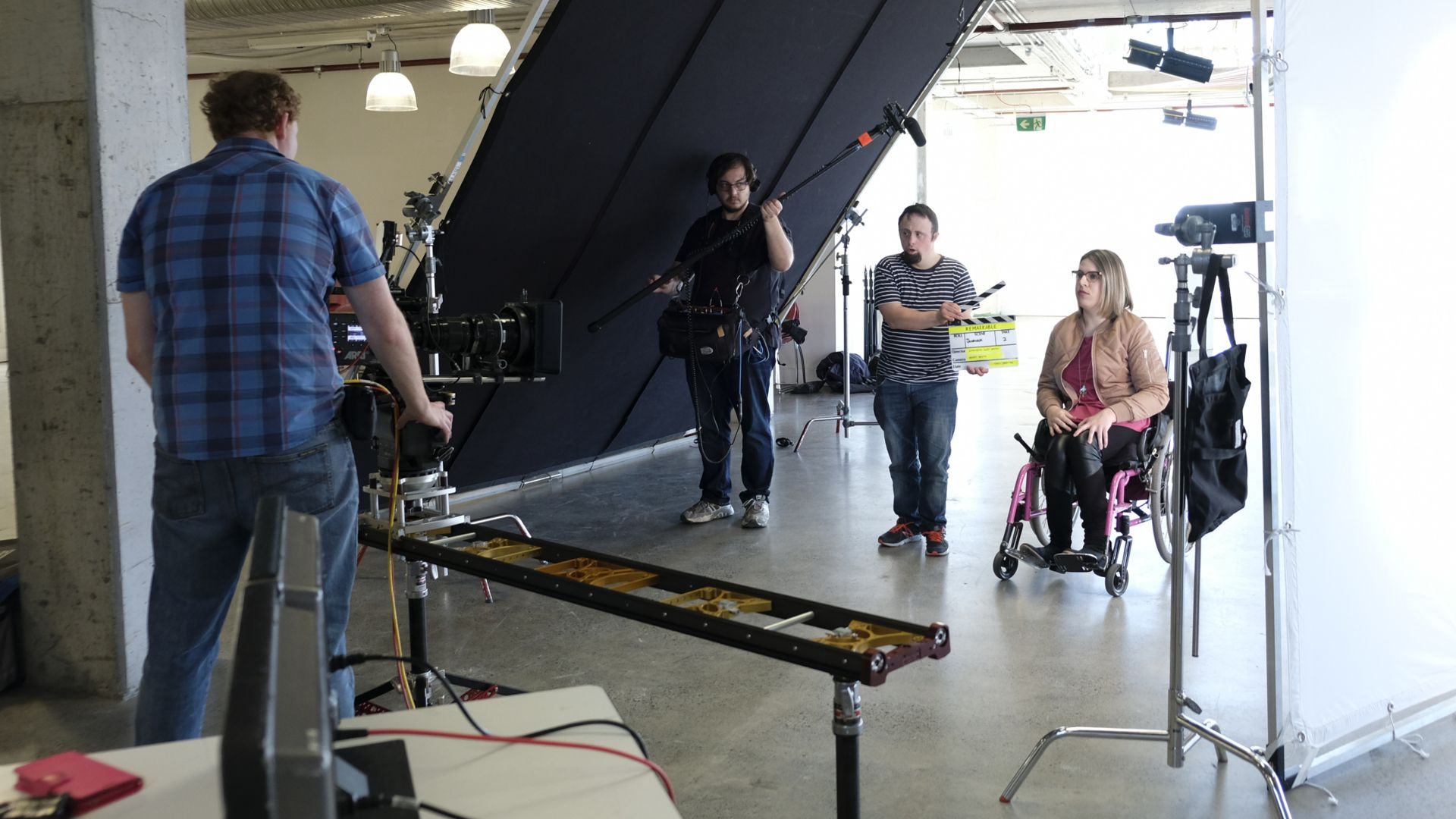 Actor and wheelchair user working on a production set  
