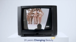 A TV resting on a white plinth, showing a 2004 ad from Dove. The ad on the screen shows six women in their underwear. The text at the bottom of the image reads: ‘20 years Changing Beauty’.