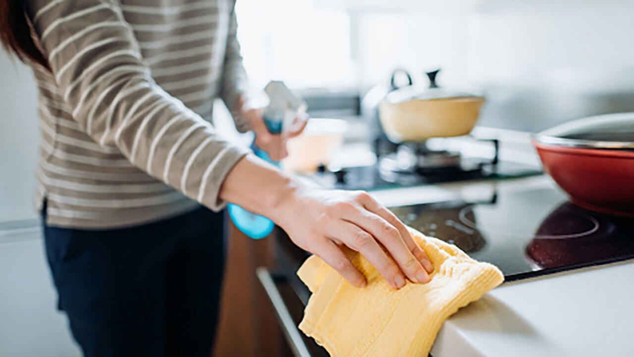 A person cleaning their kitchen