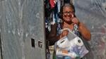 Woman receiving a donation with a cheerful thumbs-up